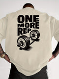 Person wearing a beige t-shirt with 'ONE MORE REP' and barbell graphic on the back.