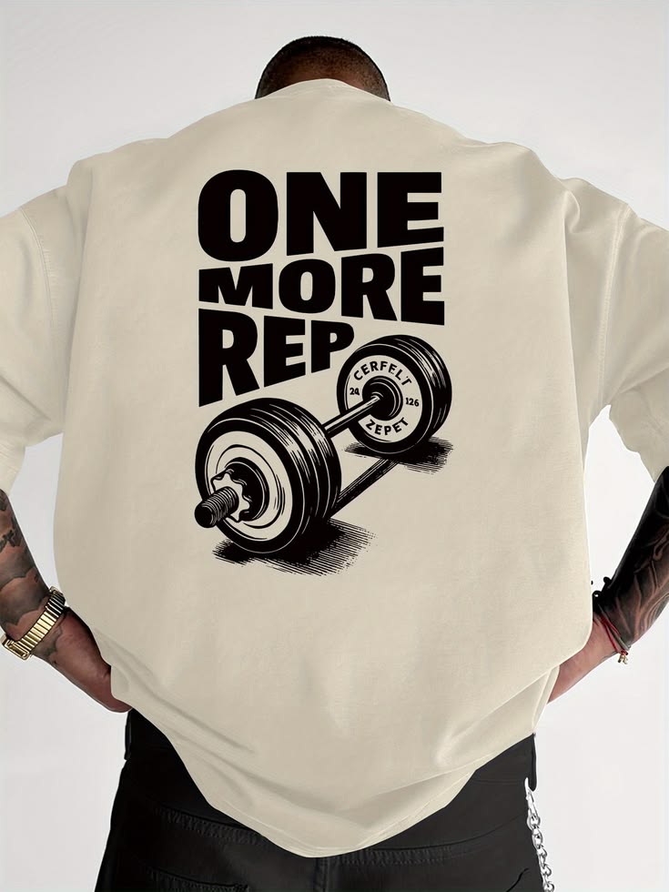 Person wearing a beige t-shirt with 'ONE MORE REP' and barbell graphic on the back.