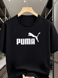 Black Puma t-shirt on a hanger with a blurred background